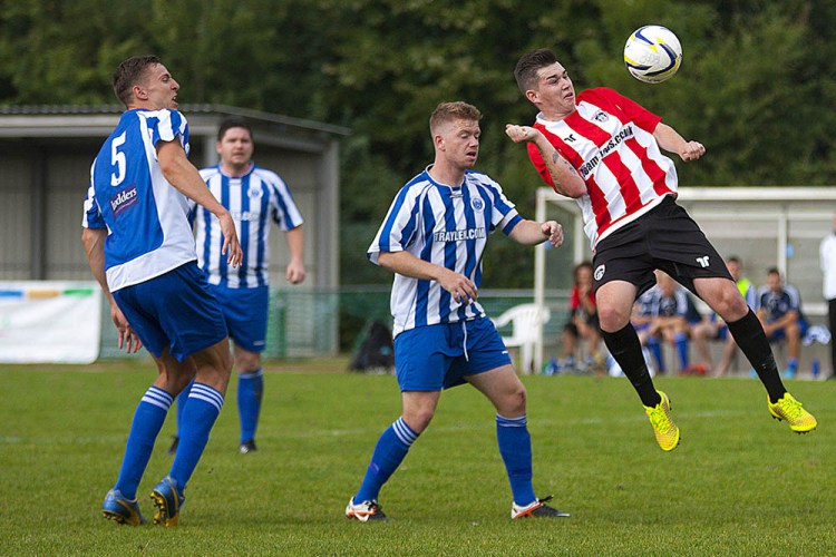 6/09/2014 Guildford City FC v Chertsey Town FC. City's Sam SPENCER heads just over the bar